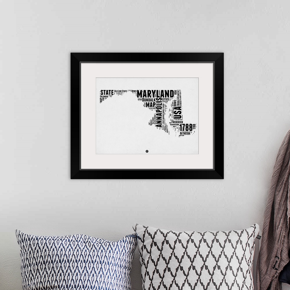 A bohemian room featuring Black and white art map of the US state Maryland.