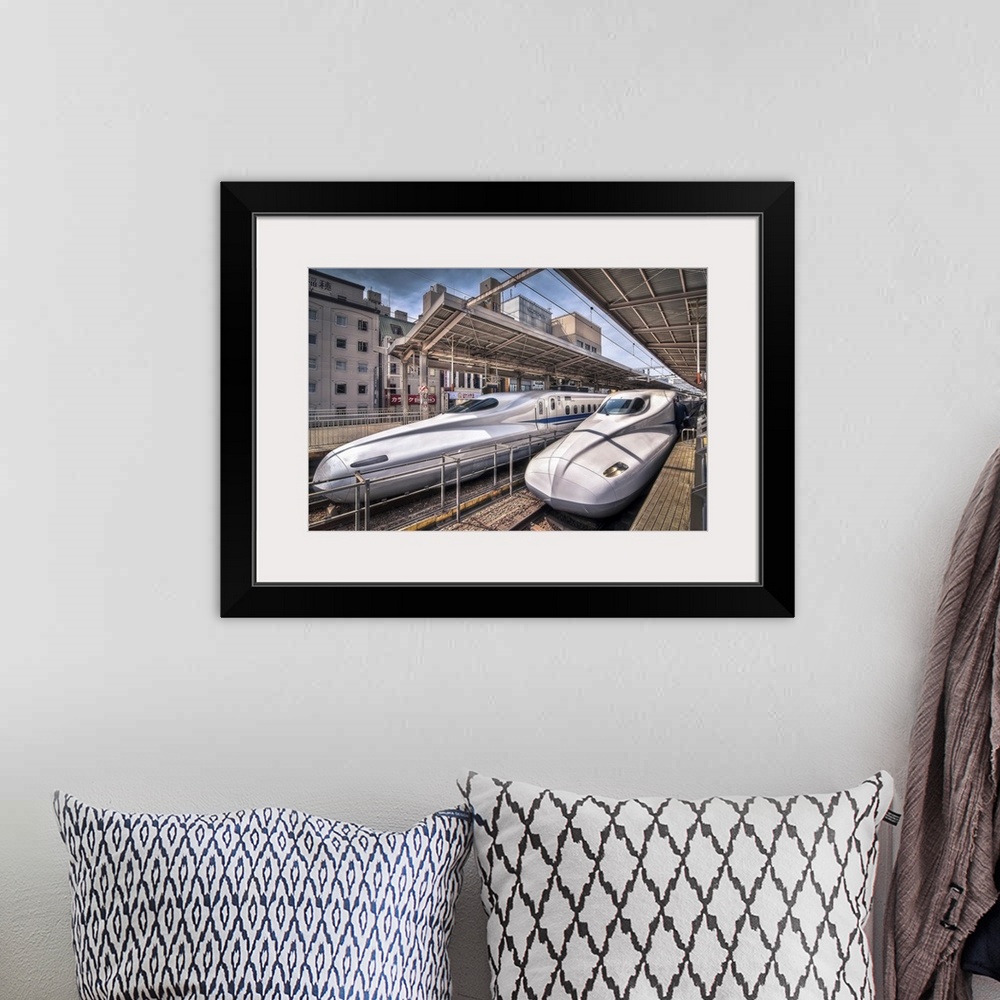 A bohemian room featuring HDR photograph of two bullet trains stopped at a station in Japan.