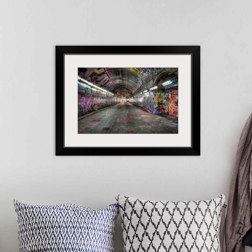 A bohemian room featuring HDR photograph of city tunnel walls covered in graffiti.