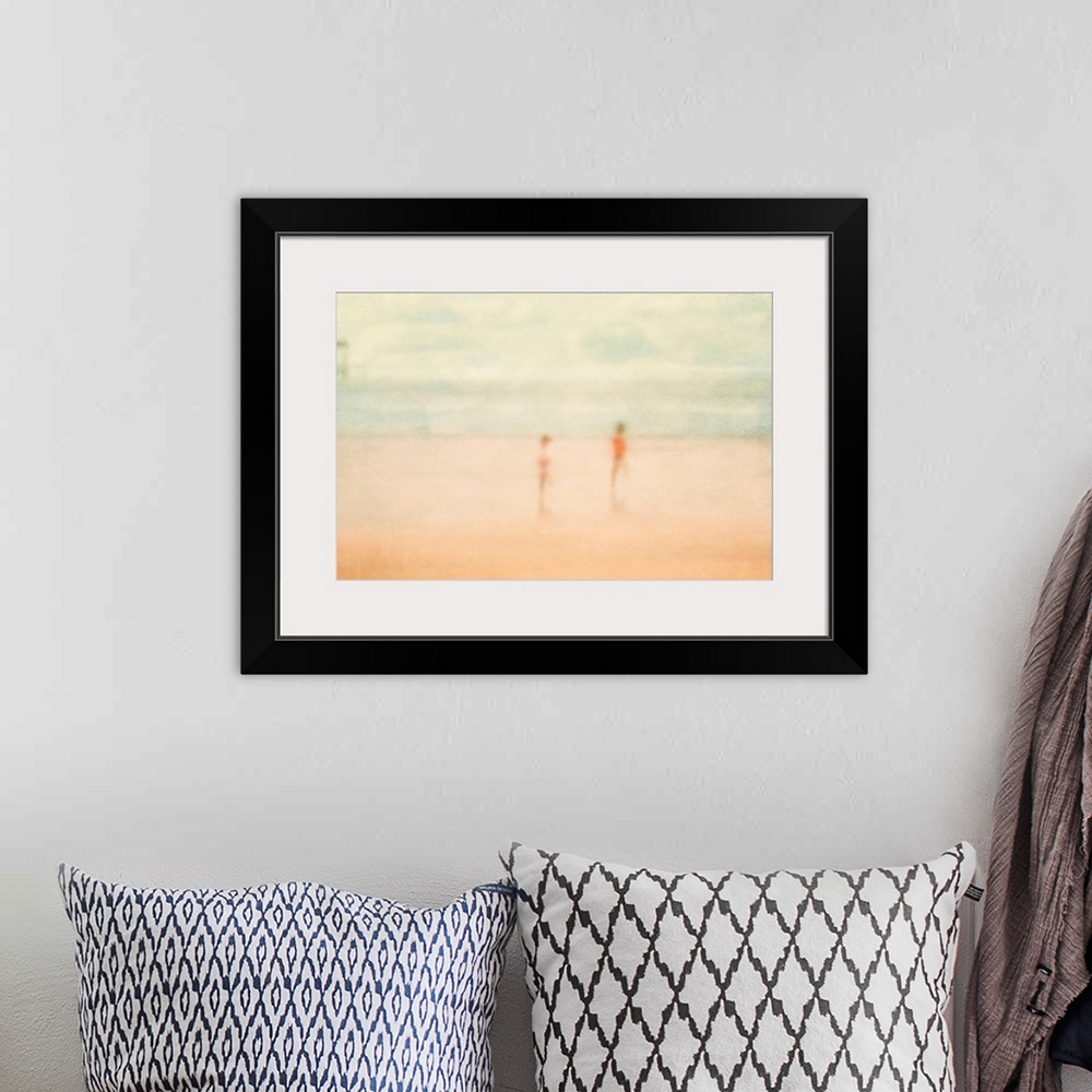 A bohemian room featuring Soft focus painting of two children standing on the beach with ocean and pier in distance.