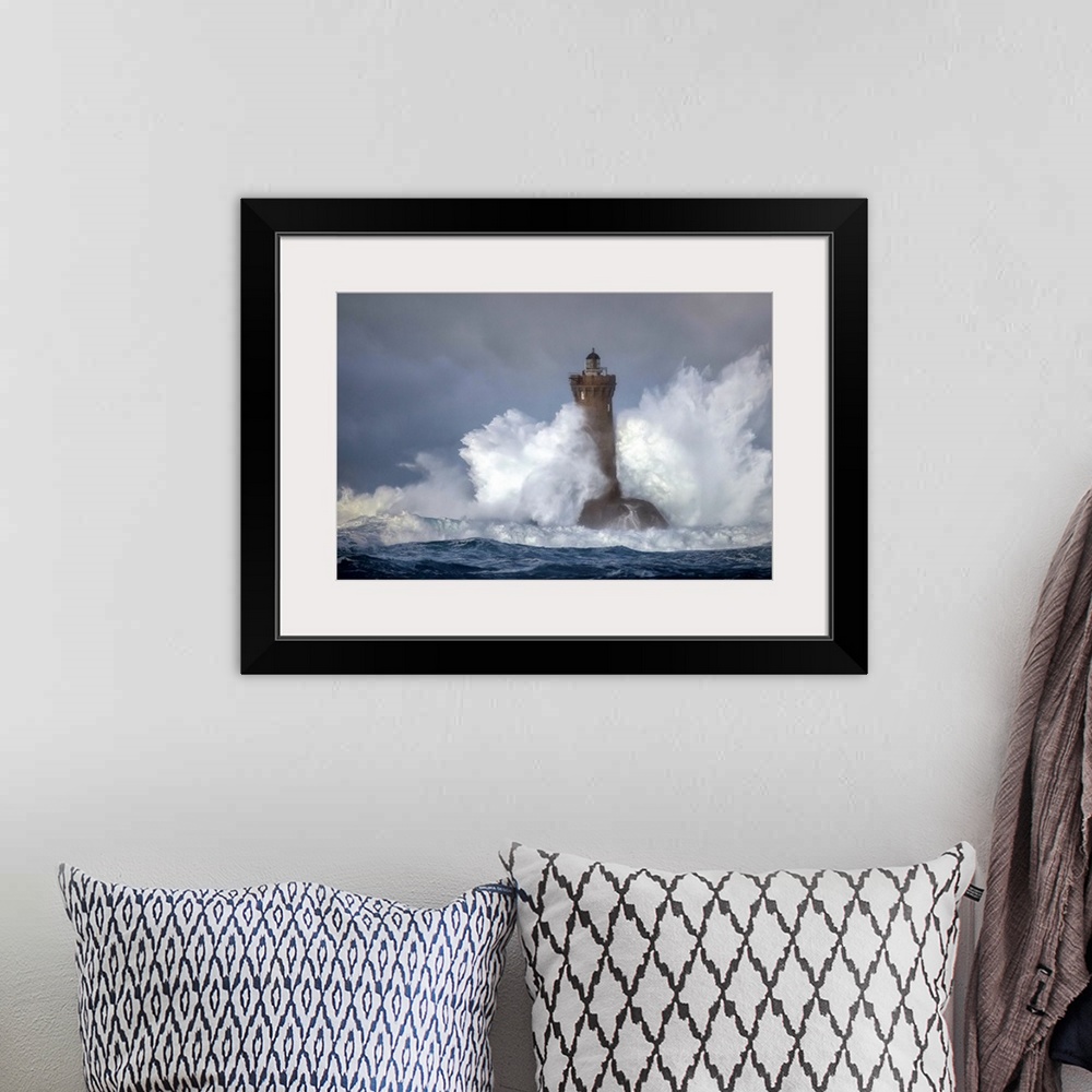 A bohemian room featuring Large wave crashing onto a lighthouse in France.