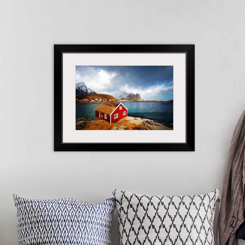 A bohemian room featuring A photograph of a red house with a rugged mountain covered in snow in the background.