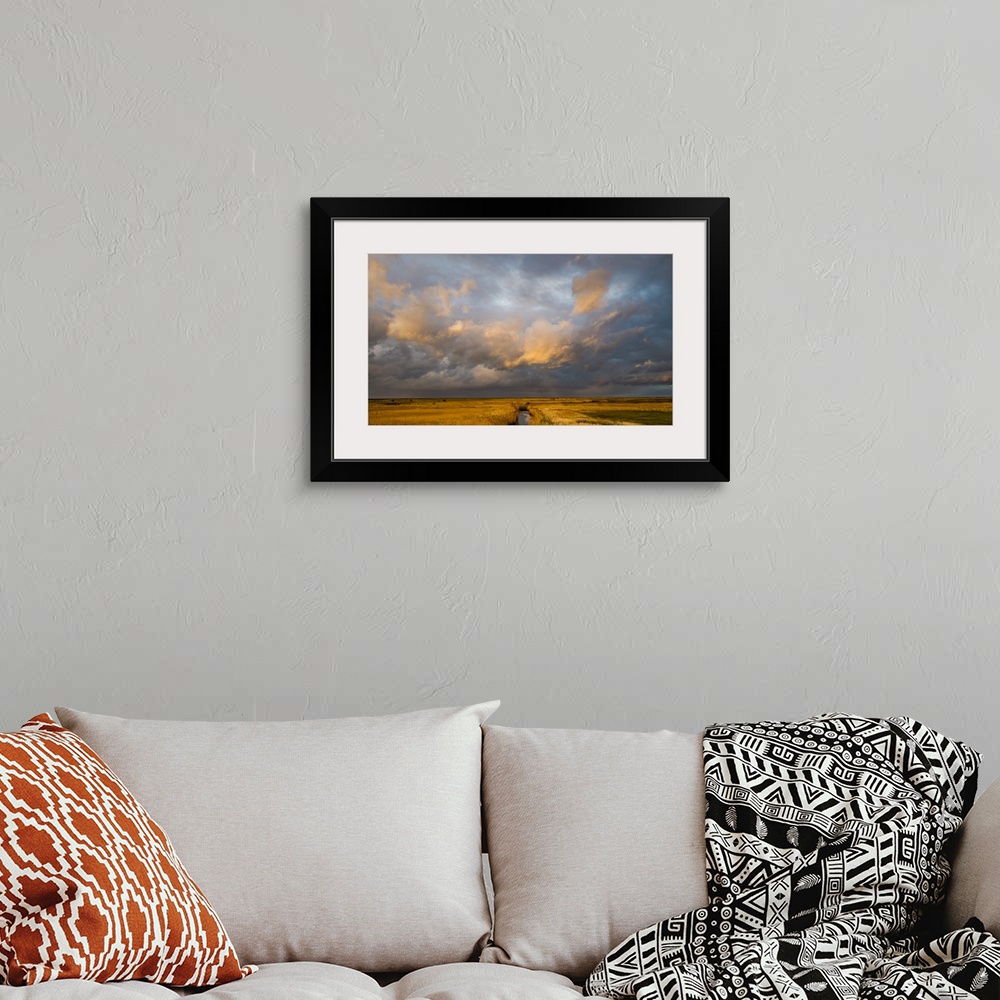 A bohemian room featuring Photograph of a beautiful skyscape in Norfolk, England, with a stream in the center moving toward...