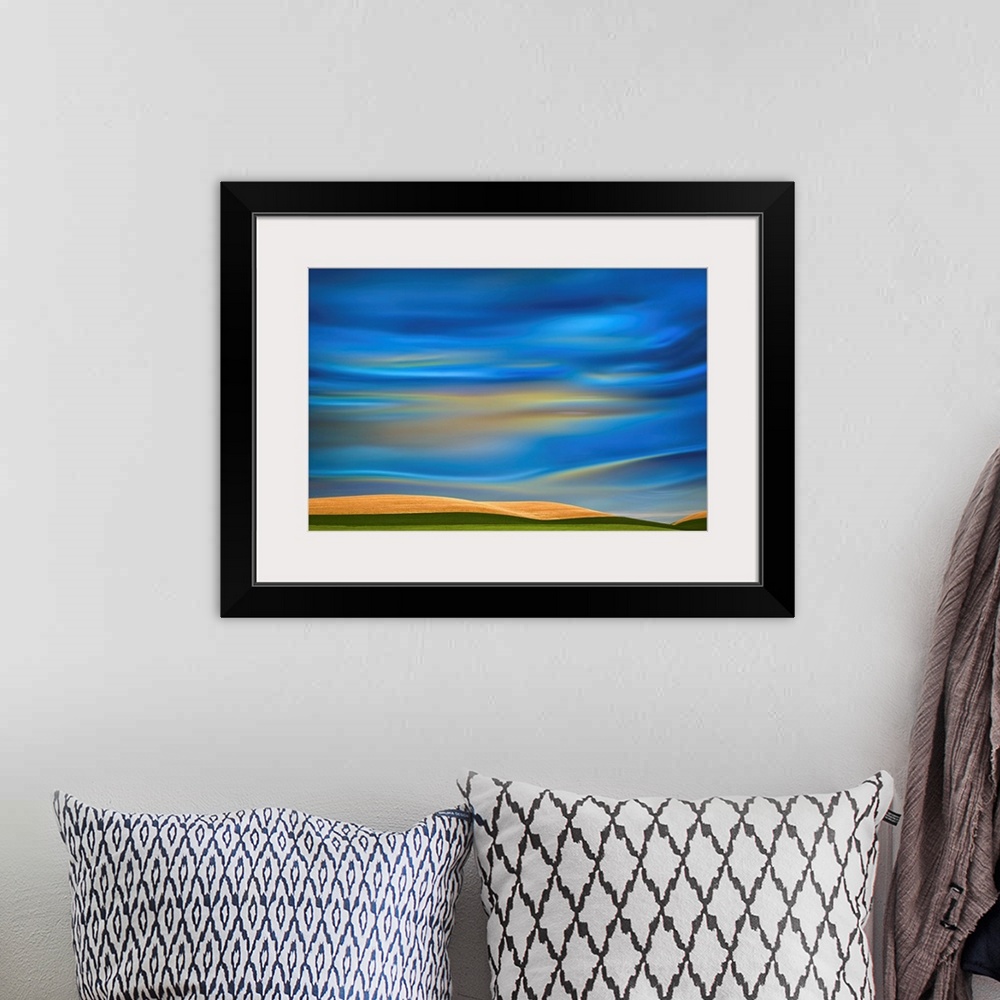 A bohemian room featuring Abstract photograph of the Palouse farmland in Washington state, with a vibrant blue motion blurr...