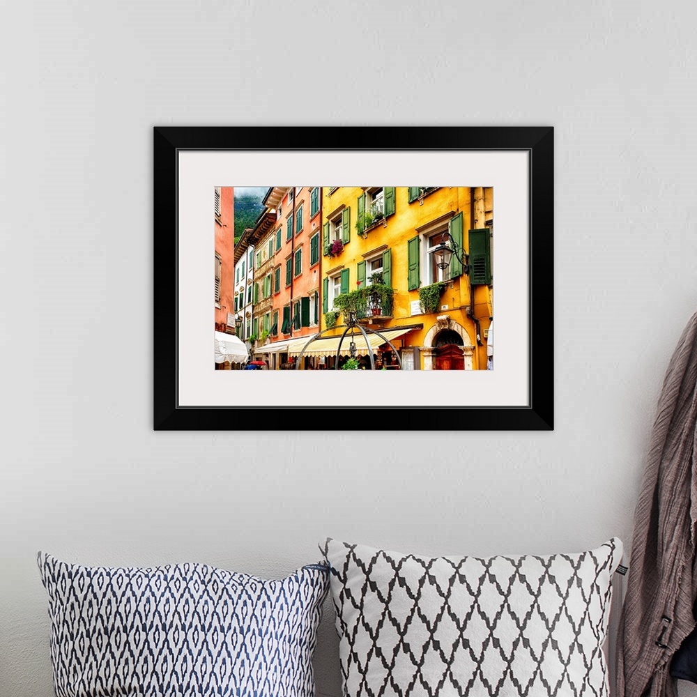 A bohemian room featuring Fine art photo of the brightly colored buildings and window shutters of an Italian street.