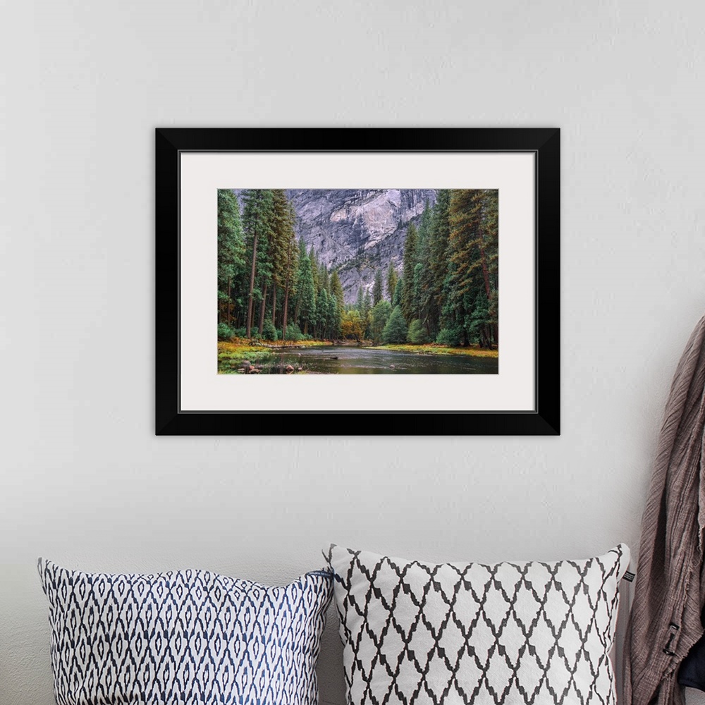 A bohemian room featuring The beautiful Merced River flowing in Yosemite National Park framed by converging fall and evergr...