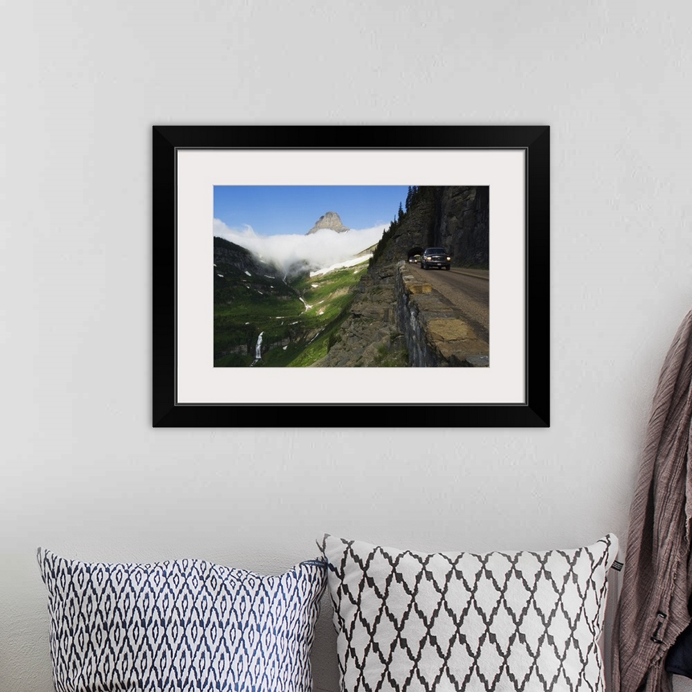 A bohemian room featuring Cars on Going to the Sun Road through mountainside tunnel, low clouds in valley, Glacier National...