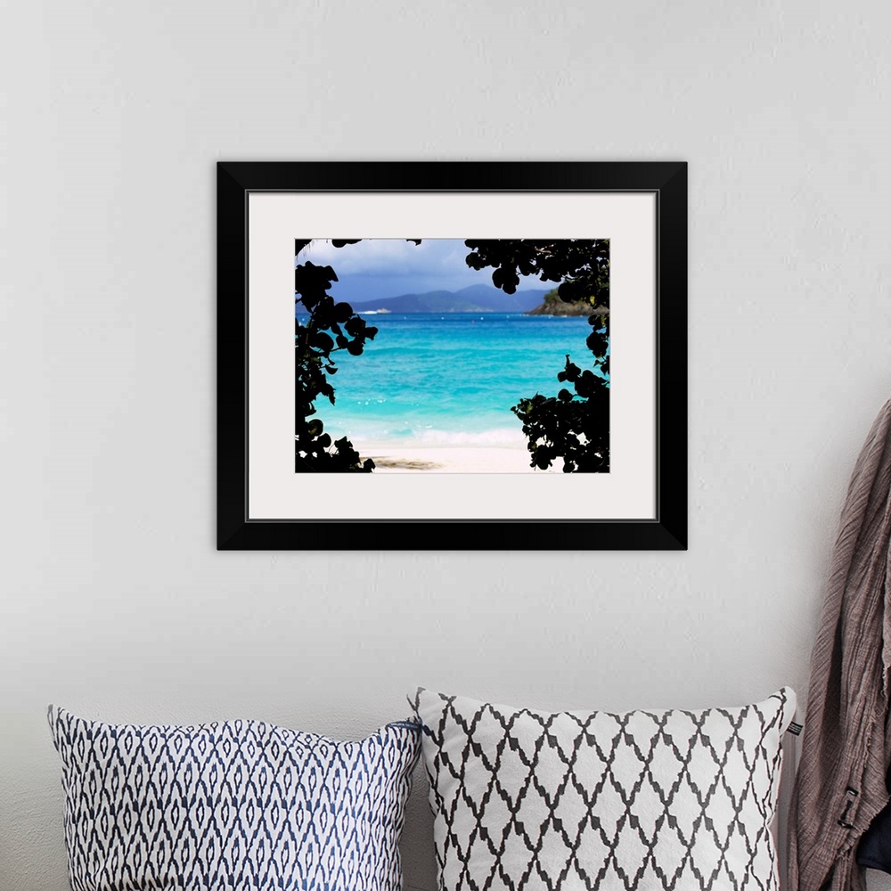 A bohemian room featuring Large photograph shows the clear water of a beach in Cinnamon Bay through a silhouetted outline o...