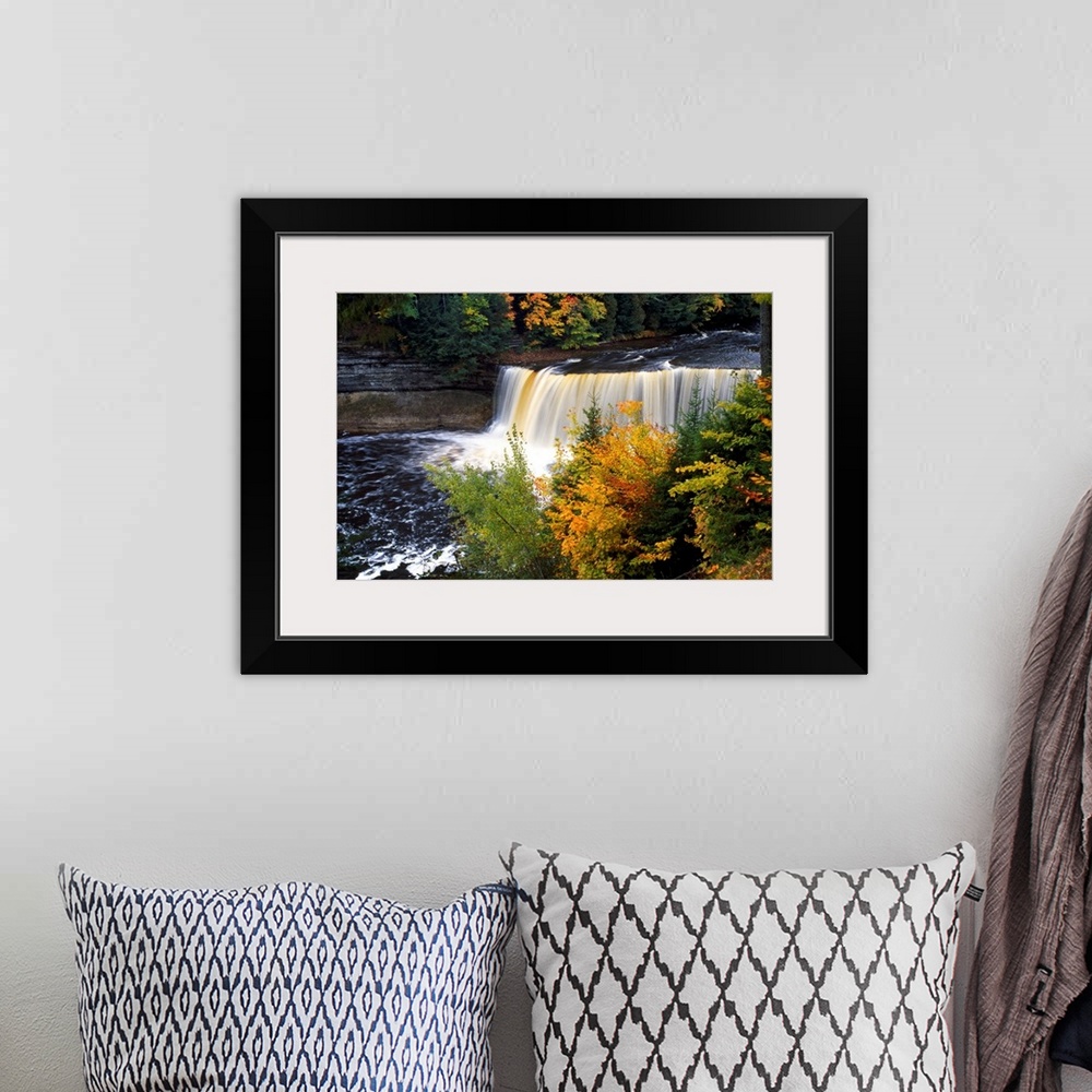 A bohemian room featuring Giant, horizontal photograph of Tahquamenon Falls surrounded by colorful fall foliage in Michigan.
