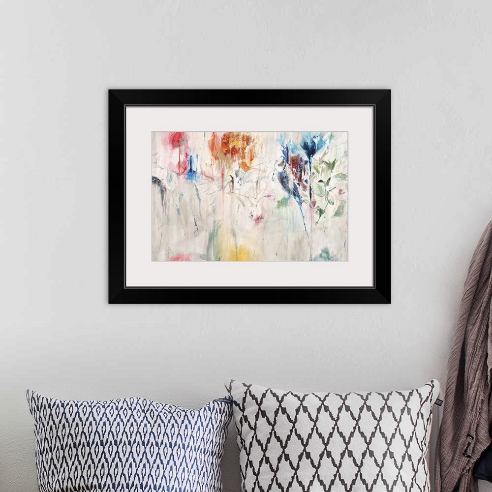 A bohemian room featuring Contemporary abstract painting of a colorful flowers against a neutral background.