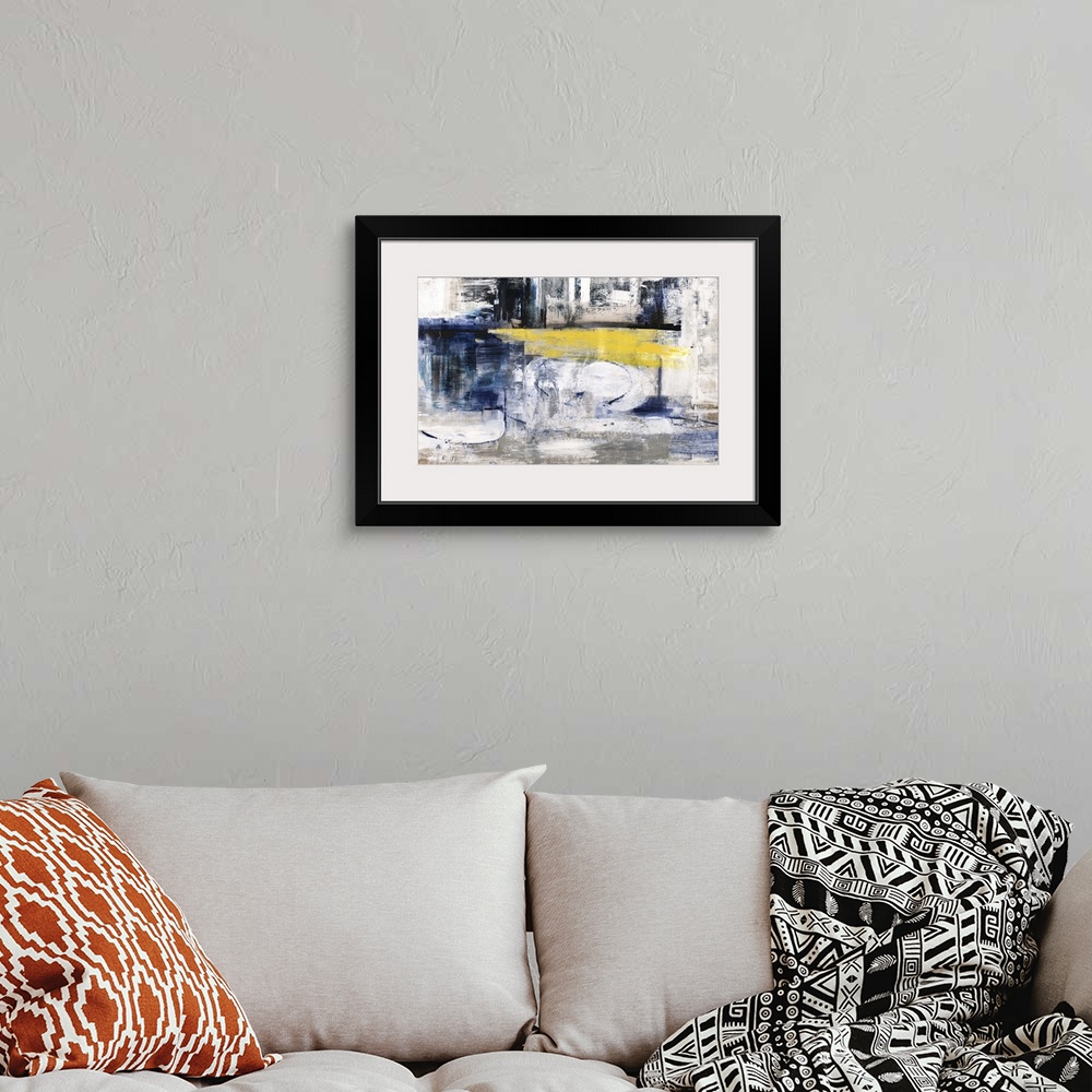 A bohemian room featuring Contemporary abstract artwork in dark shades of blue and black with a yellow streak in the center.