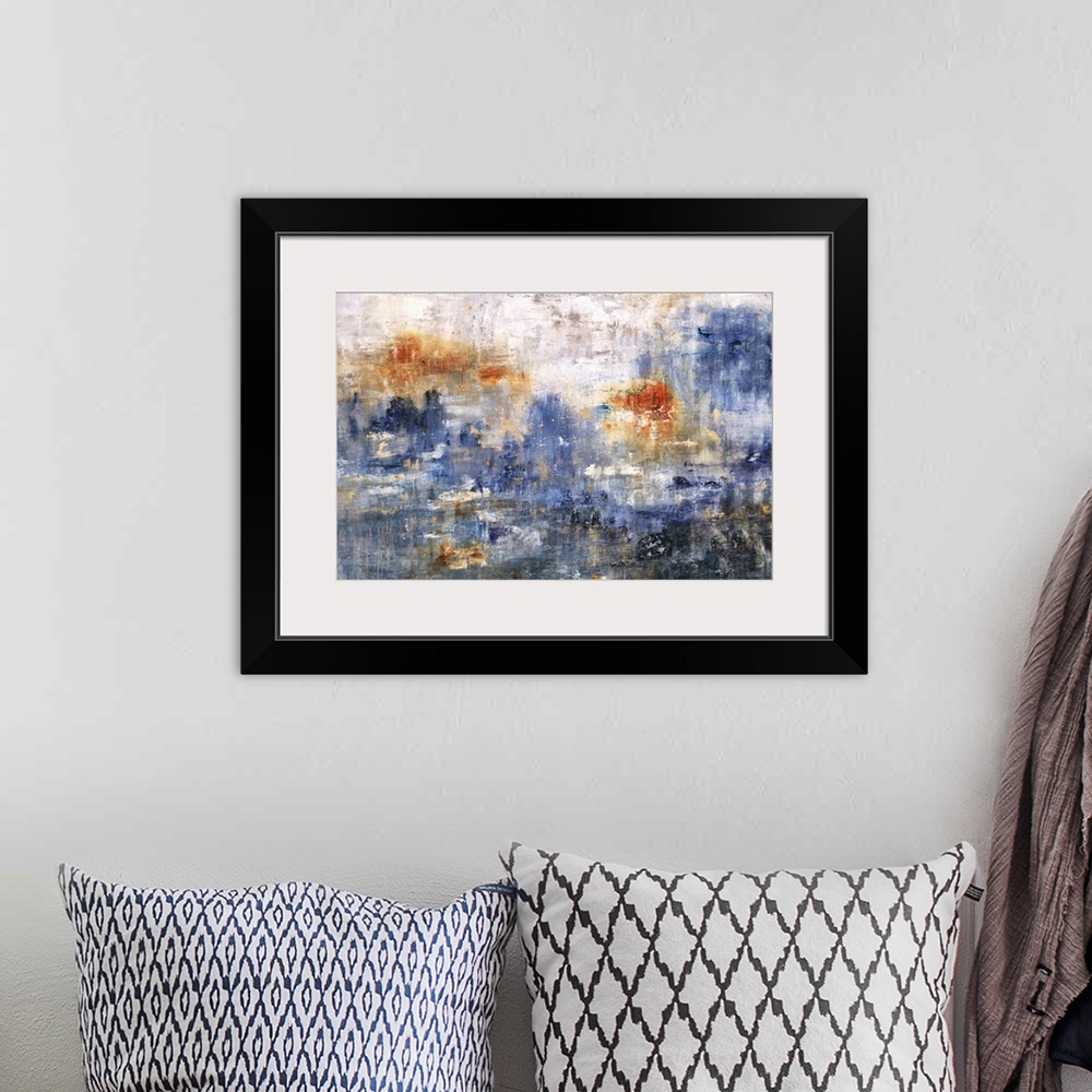 A bohemian room featuring Large abstract art with shades of blue, orange, and gray.