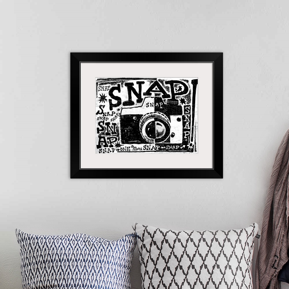 A bohemian room featuring Black and white stylized illustrated camera with the word “Snap!” repeated all over.