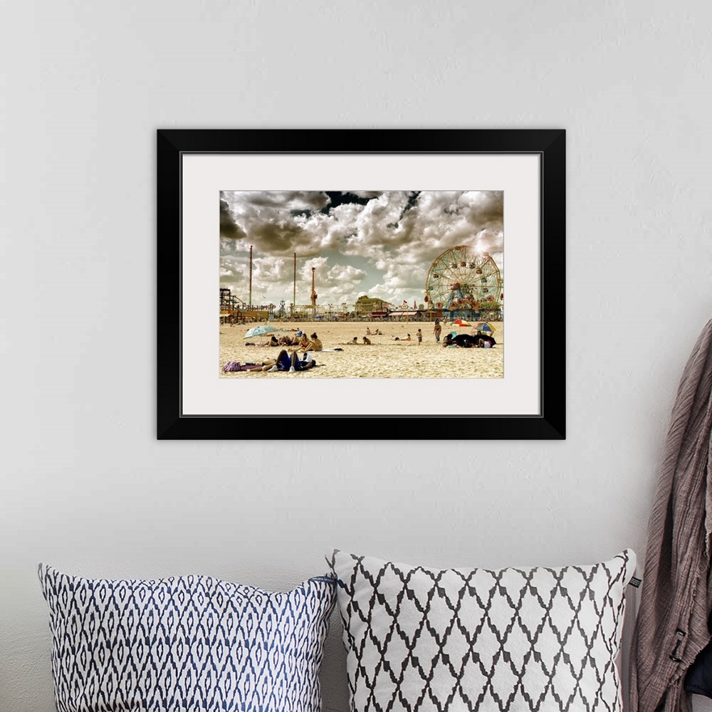 A bohemian room featuring Photo of dramatic clouds over the sandy beach of Coney Island with carnival rides in the background.