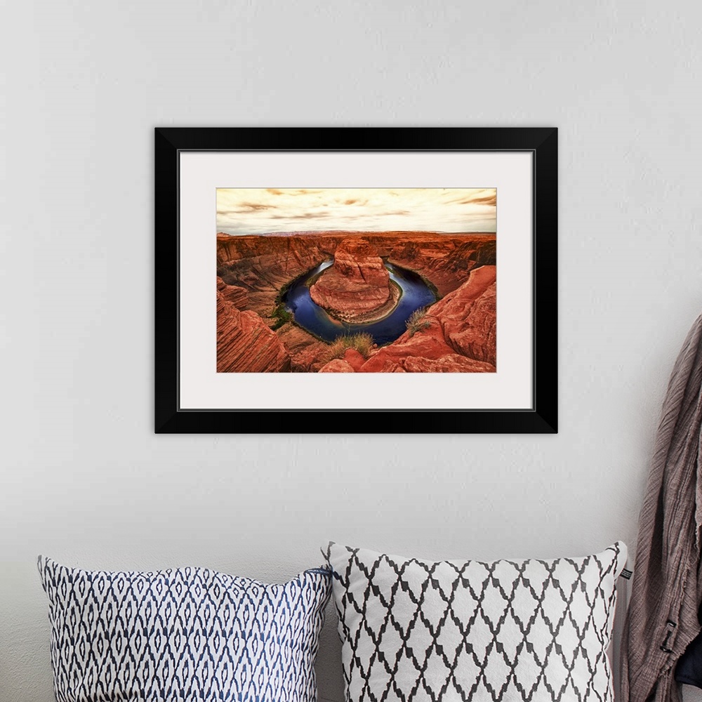 A bohemian room featuring Fine art photograph of Horseshoe Bend in the Arizona landscape under a pale cloudy sky.