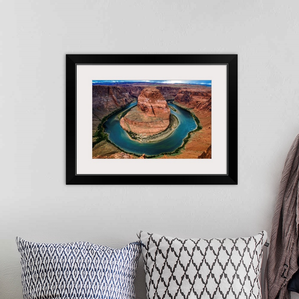 A bohemian room featuring Horseshoe Bend section of the Colorado River with partly cloudy skies and rain in the distance.