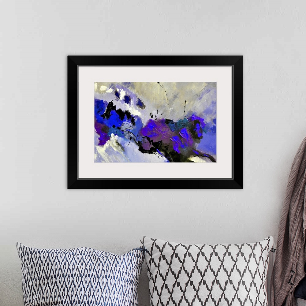 A bohemian room featuring Abstract painting in dark shades of black, blue and gray with splatters of paint overlapping.