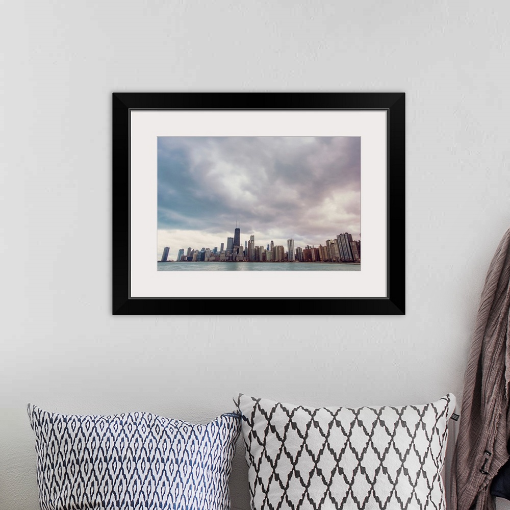 A bohemian room featuring Photo of Chicago's skyline under dramatic clouds.