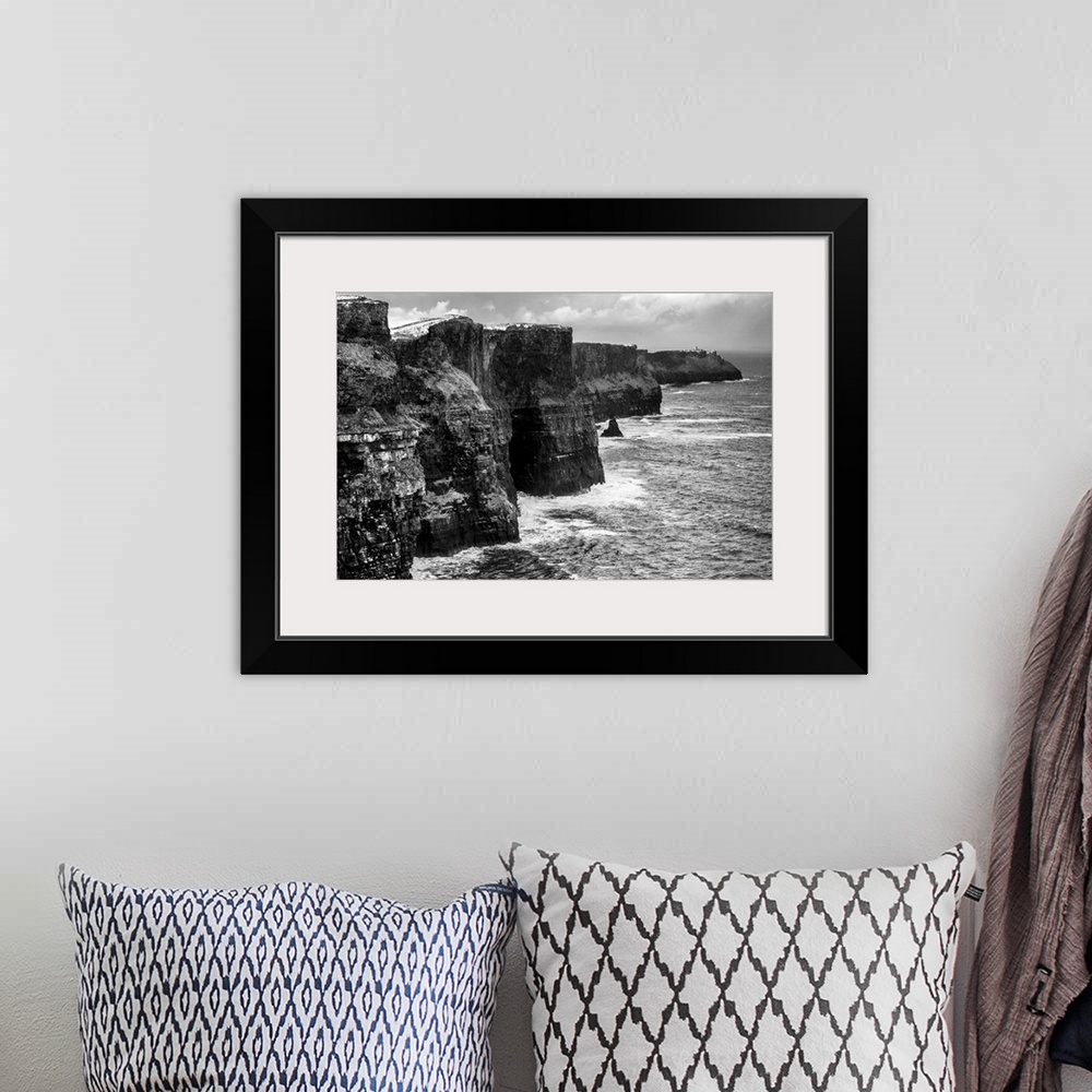 A bohemian room featuring Landscape photograph of the picturesque Cliffs of Moher, located at the southwestern edge of the ...