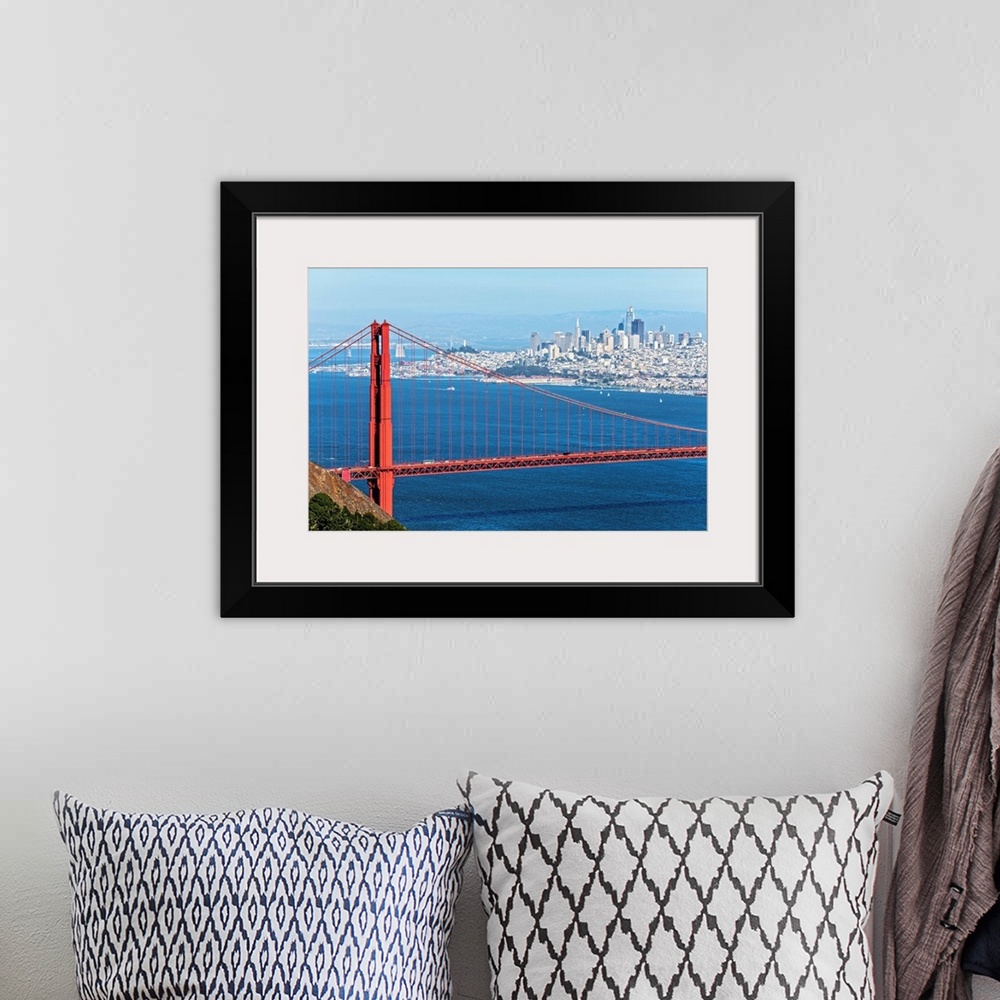 A bohemian room featuring Photograph of the Golden Gate Bridge with San Francisco's skyscrapers in the background.