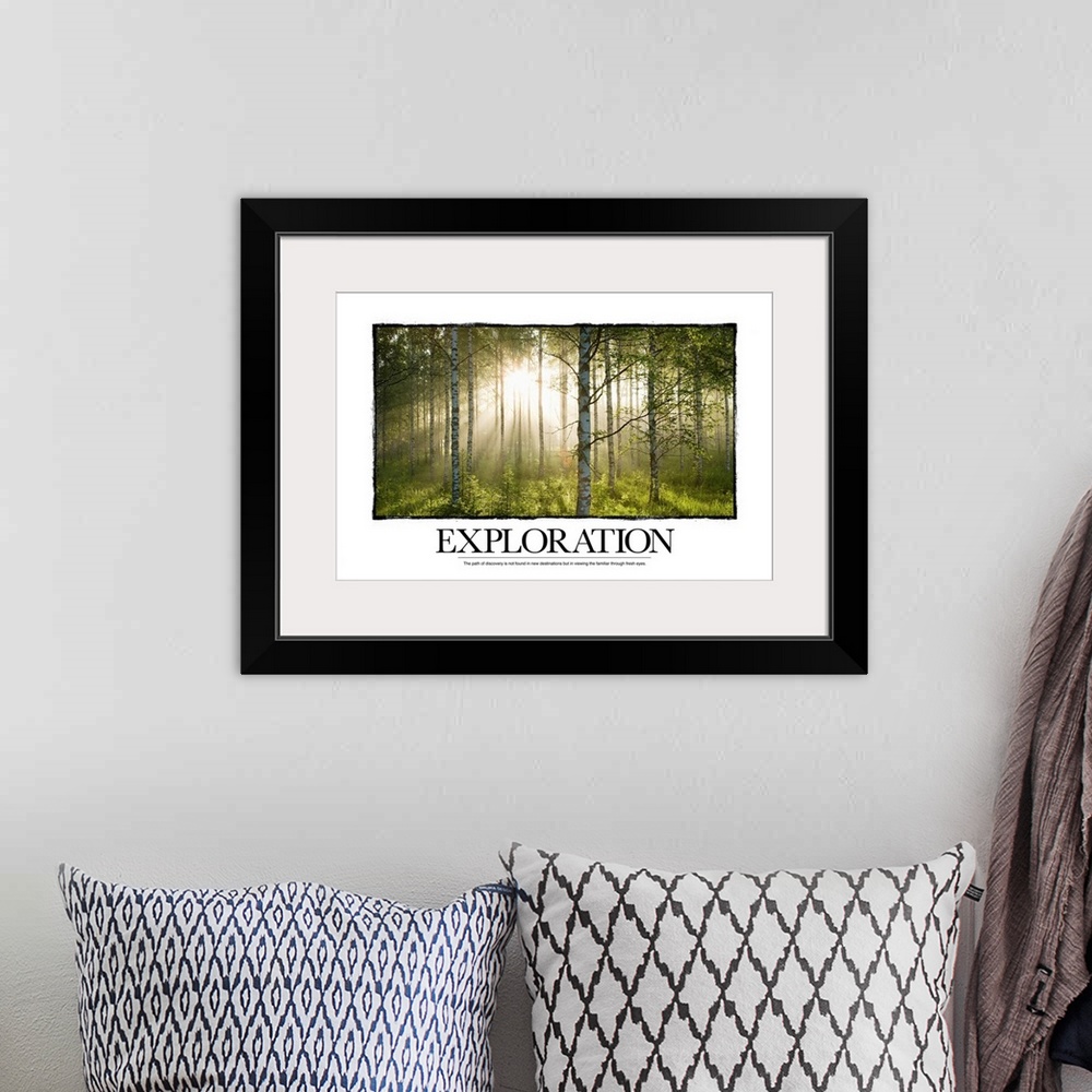 A bohemian room featuring Big canvas print of a forest with a blinding sun shining through and text at the bottom.