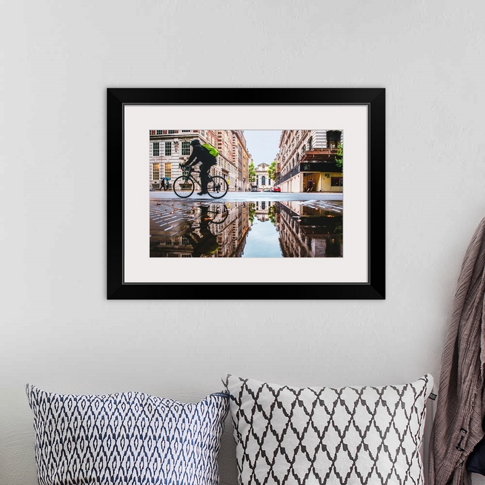 A bohemian room featuring Photograph of a biker reflecting into a puddle in London, England.
