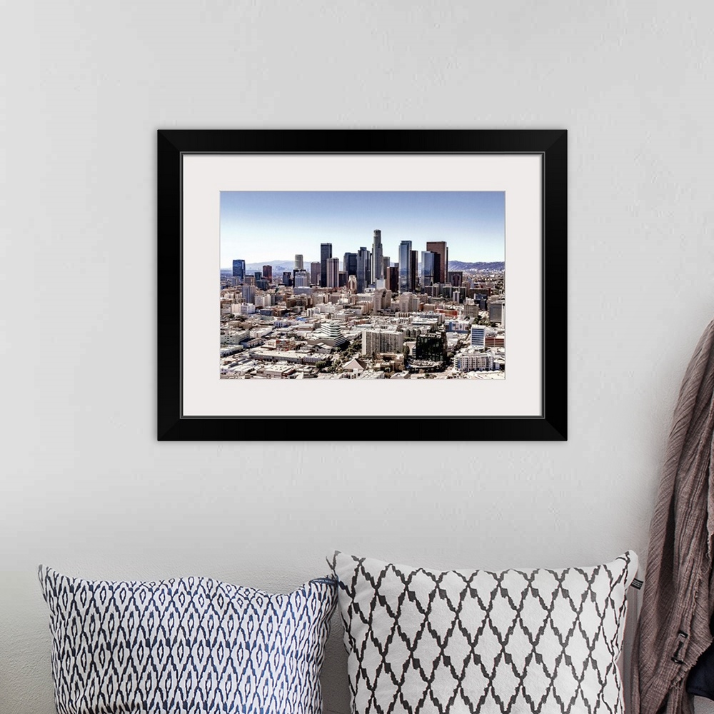 A bohemian room featuring Skyscrapers and surrounding buildings of the Los Angeles skyline under a blue sky, California.