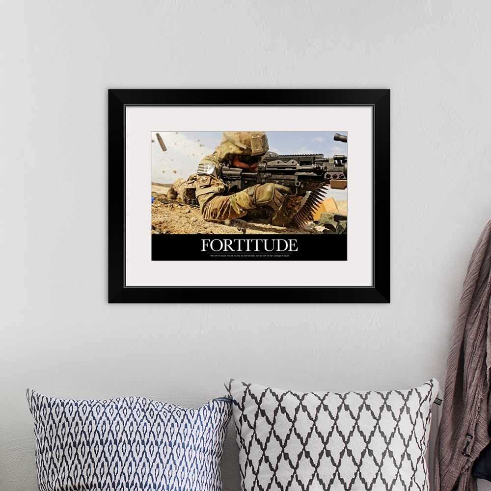 A bohemian room featuring Inspirational poster with the image of a soldier on the ground shooting a gun with shells flying ...