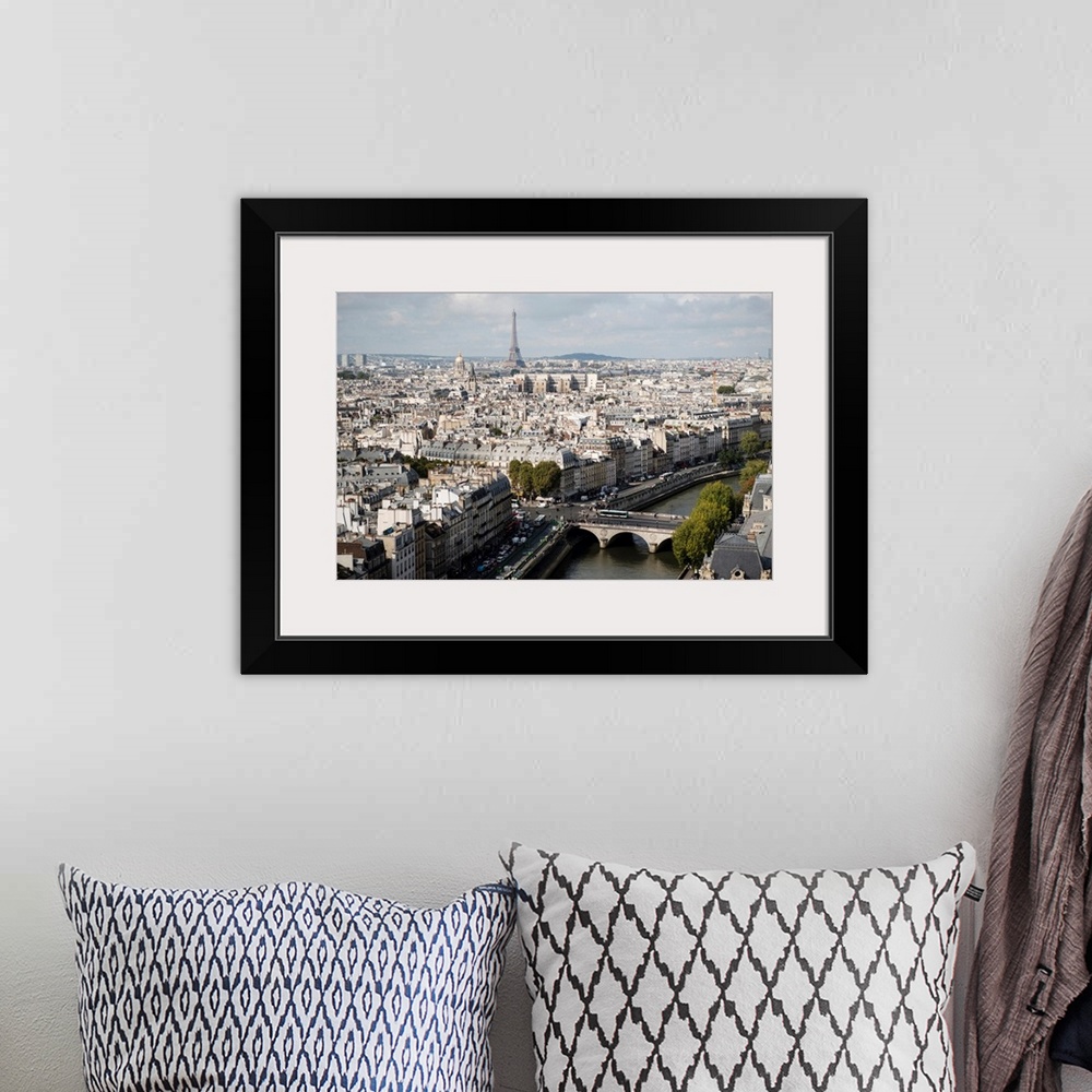 A bohemian room featuring Photograph of a Paris Cityscape with the Eiffel Tower towering over the city.