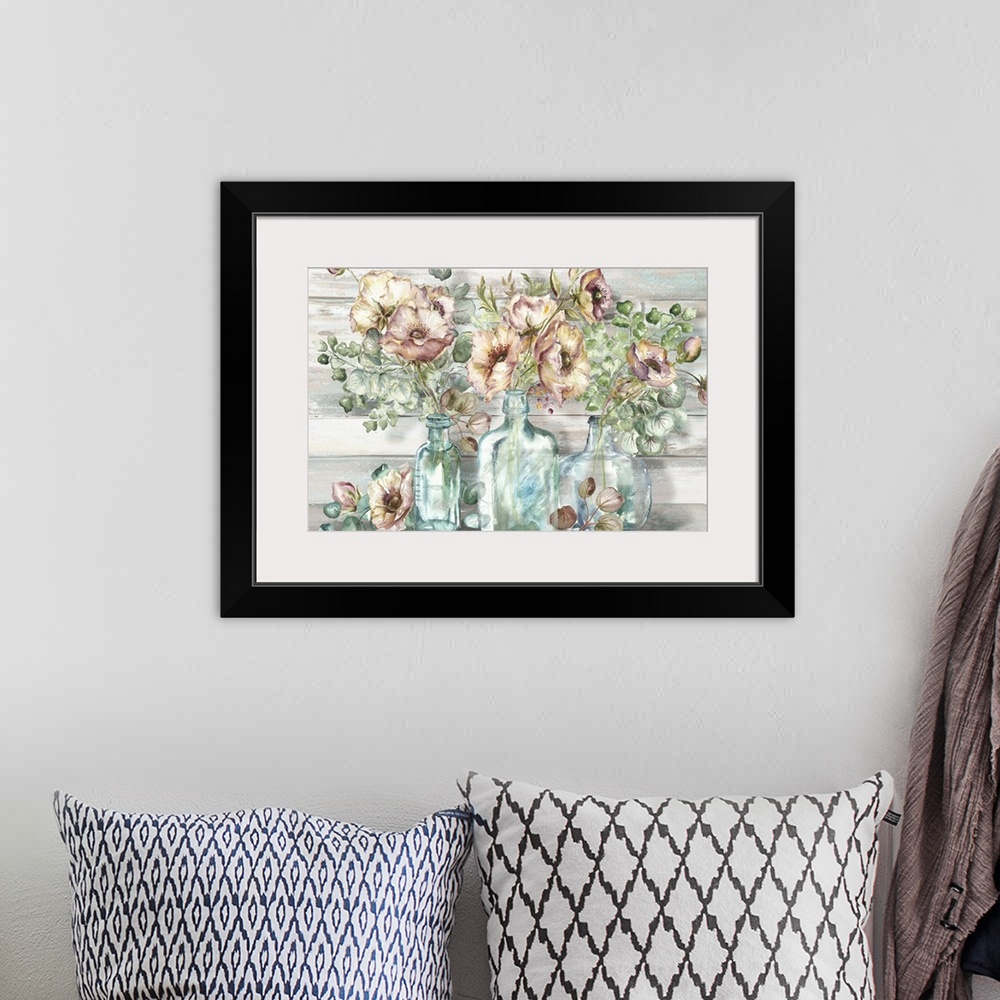A bohemian room featuring A decorative watercolor painting of a glass mason jar full of poppy and eucalyptus in subdue tones.
