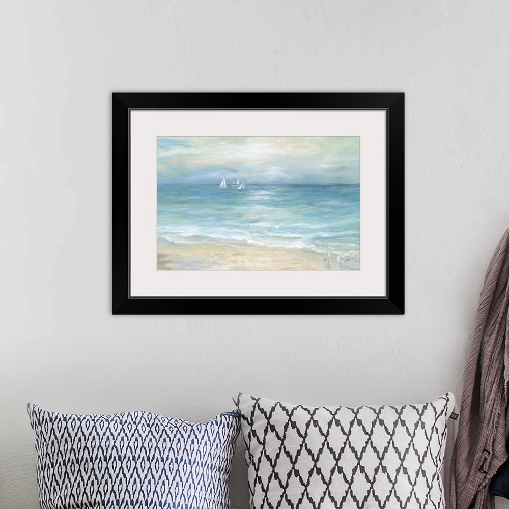 A bohemian room featuring A contemporary painting of a seascape with sailboats off in the distance and shorebird walking al...