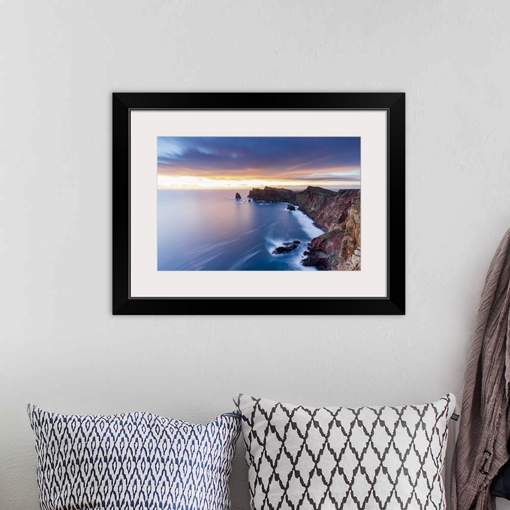 A bohemian room featuring Dramatic sky at dawn on cliffs washed by ocean from Ponta Do Rosto viewpoint, Sao Lourenco Penins...