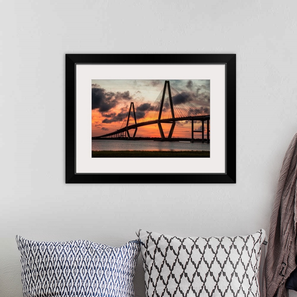 A bohemian room featuring Arthur Ravenel Jr. Bridge crossing the Cooper River at sunset.