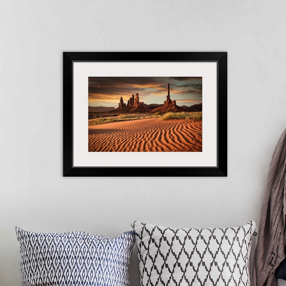 A bohemian room featuring Sunrise over Totem Pole in Monument Valley.