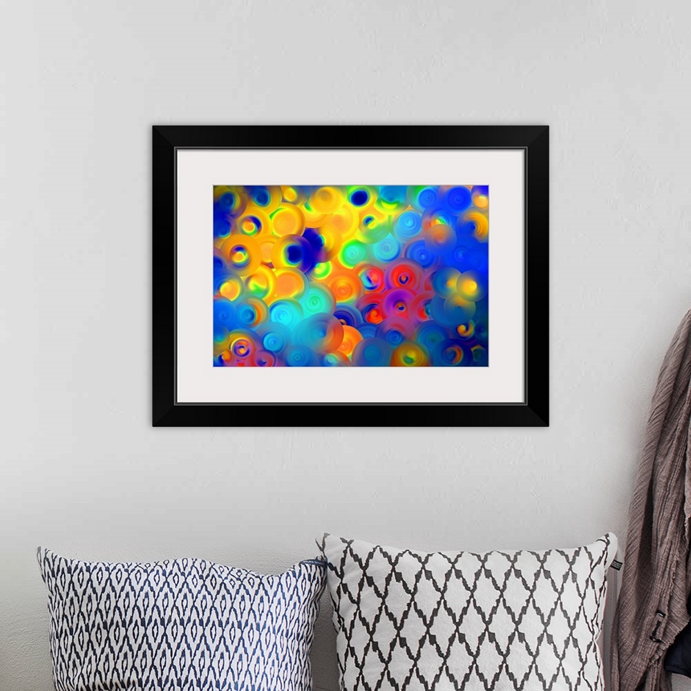 A bohemian room featuring Abstract artwork of overlapping swirling circles in vibrant yellow, red, and blue.