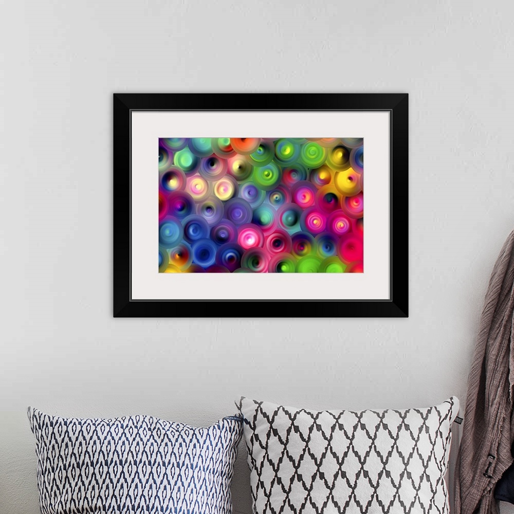 A bohemian room featuring Abstract artwork of overlapping swirling circles in bright rainbow colors.