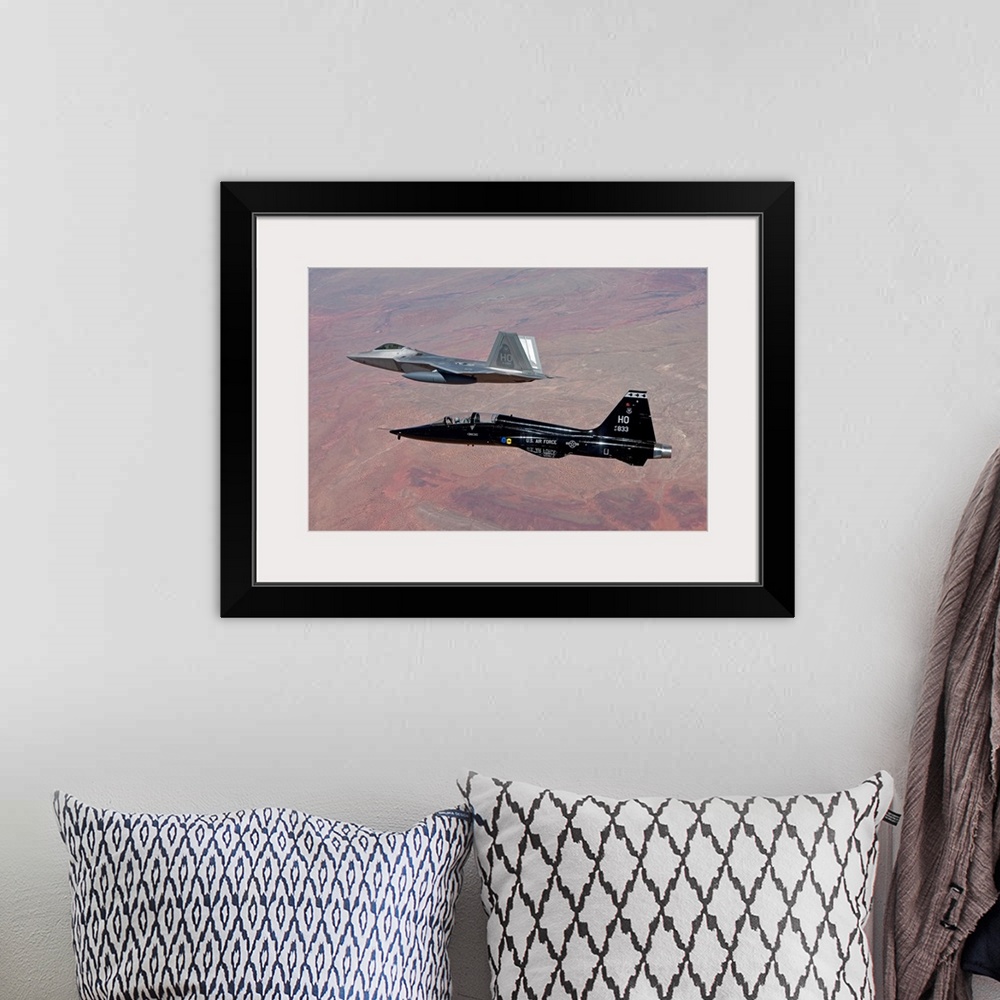A bohemian room featuring An F-22 Raptor from the 49th Fighter Wing flies in formation with a T-38 Talon while on a trainin...