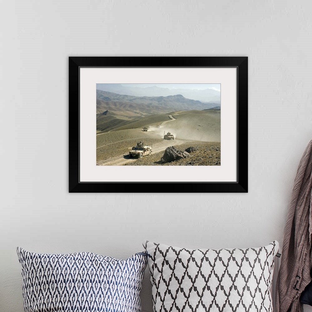 A bohemian room featuring Humvees traverse rugged mountain roads