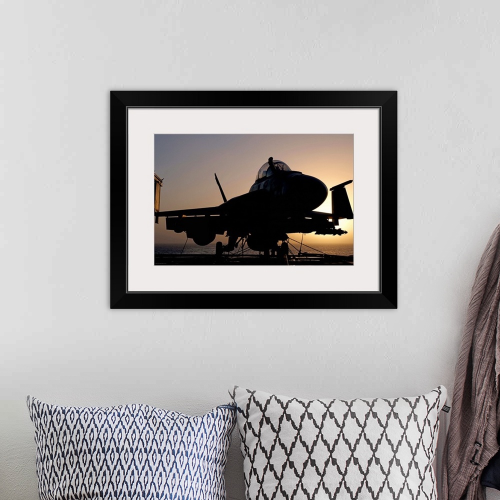 A bohemian room featuring Silhouette of a US Navy F/A-18E Super Hornet parked on the flight deck of aircraft carrier USS Ni...