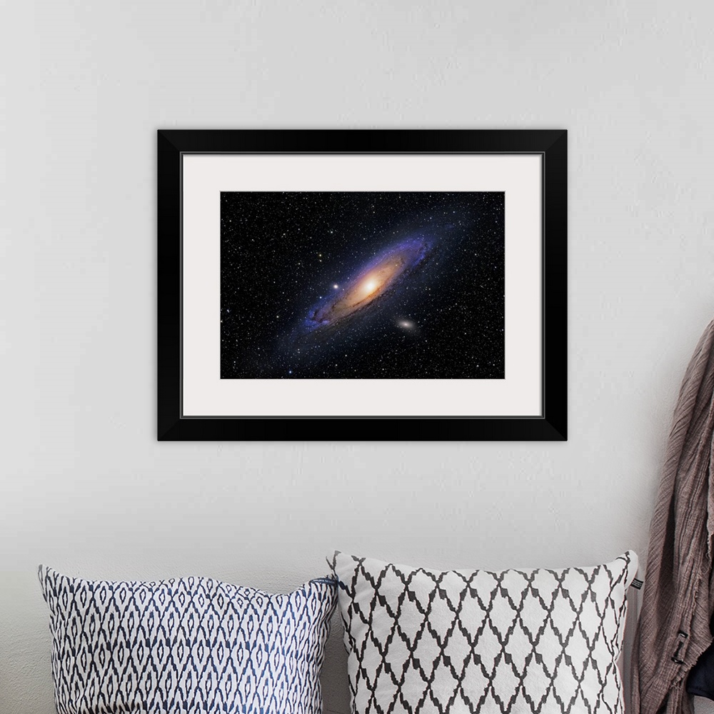A bohemian room featuring Image of a galaxy amongst many tiny stars printed on canvas.