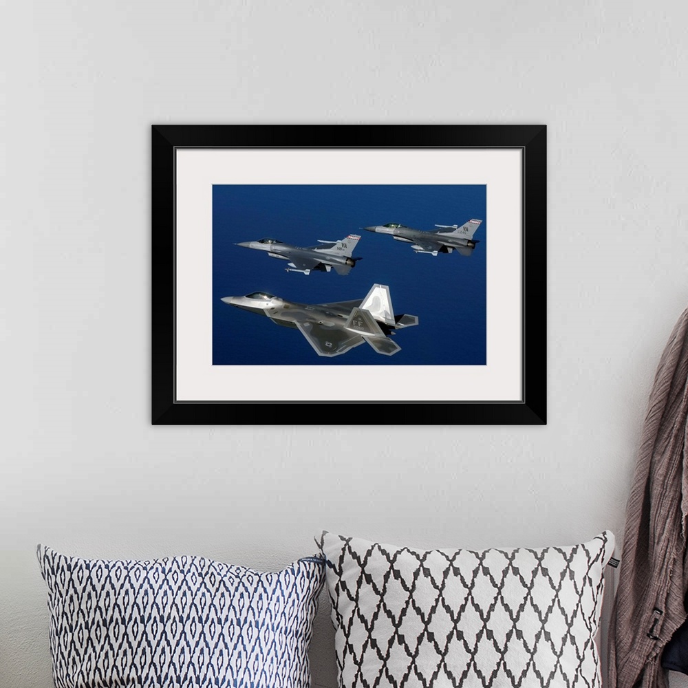 A bohemian room featuring Three F-22A Raptor aircrafts fly in formation.