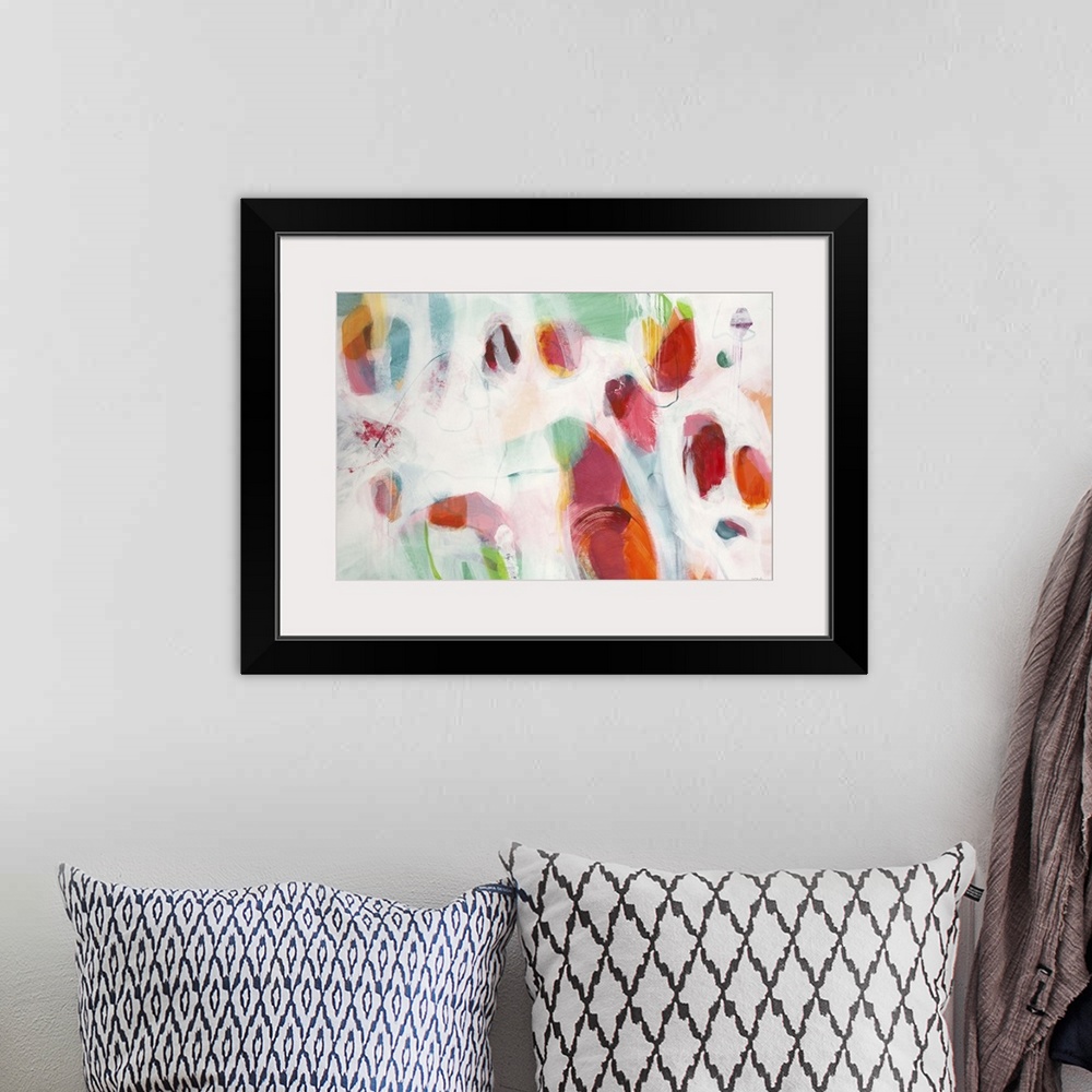 A bohemian room featuring A contemporary abstract painting using splashes of red and pale green against an off white backgr...