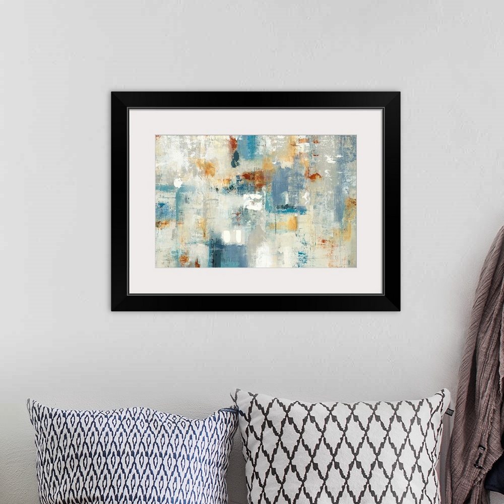 A bohemian room featuring Large abstract painting with shades of blue, yellow, orange, gray, and white.