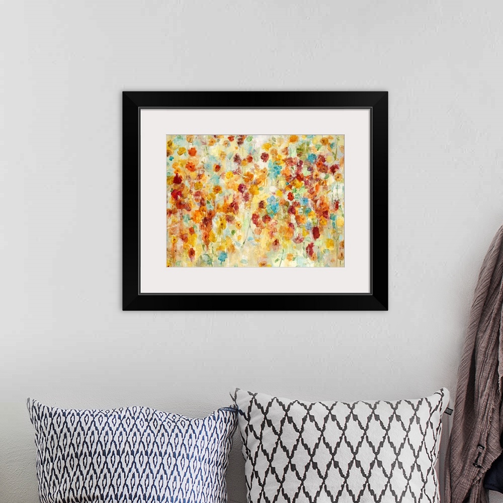 A bohemian room featuring A contemporary abstract flower painting using warm red orange and red tones.