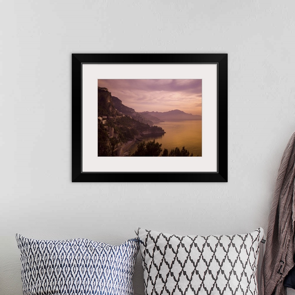 A bohemian room featuring A beautiful sunset turns this view of the Amalfi Coast purple and orange