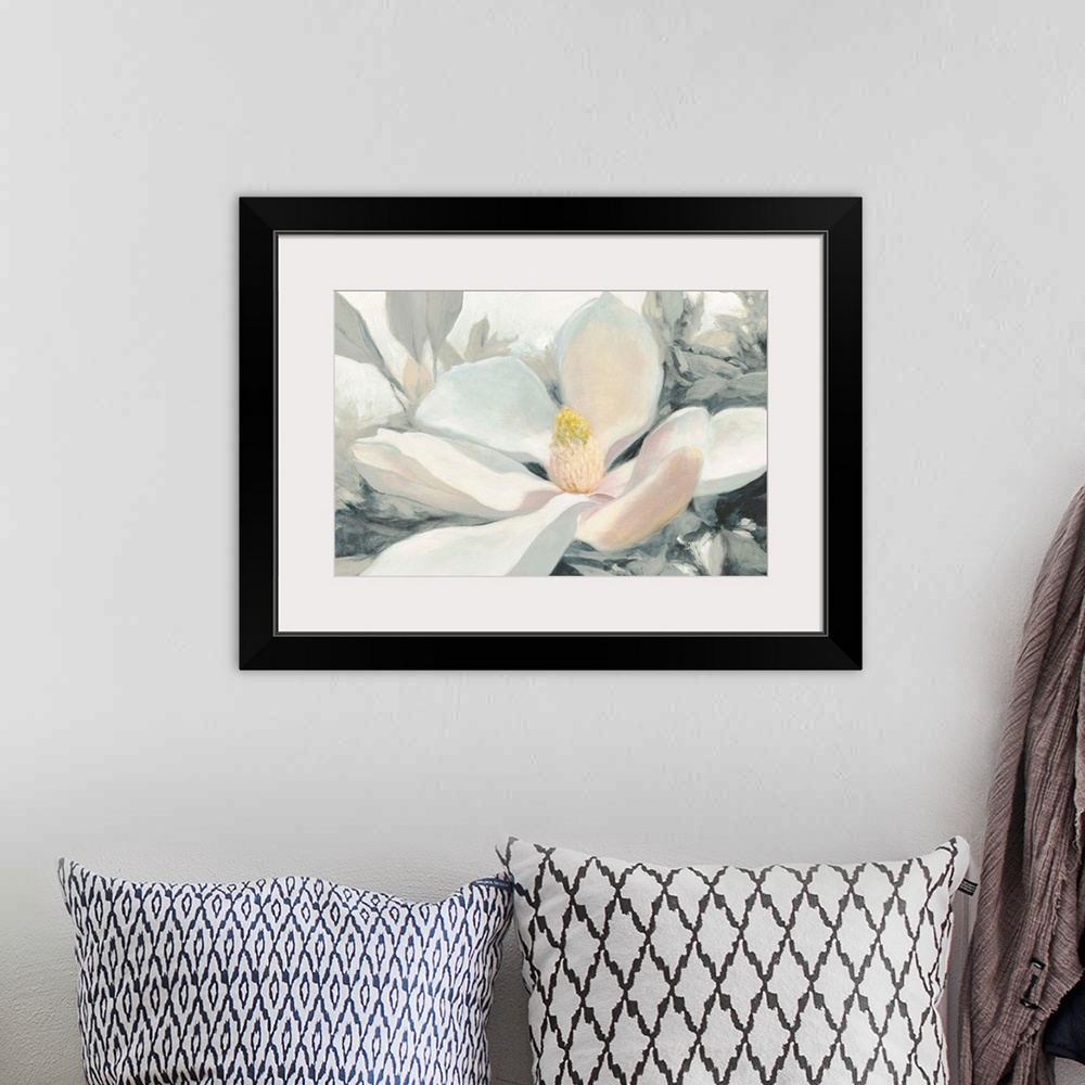 A bohemian room featuring A large close up painting of a magnolia bloom in shades of yellow, pink and gray.