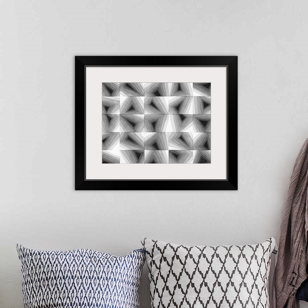 A bohemian room featuring Contemporary abstract artwork of a grid of geometric shapes in gradating gray tones.