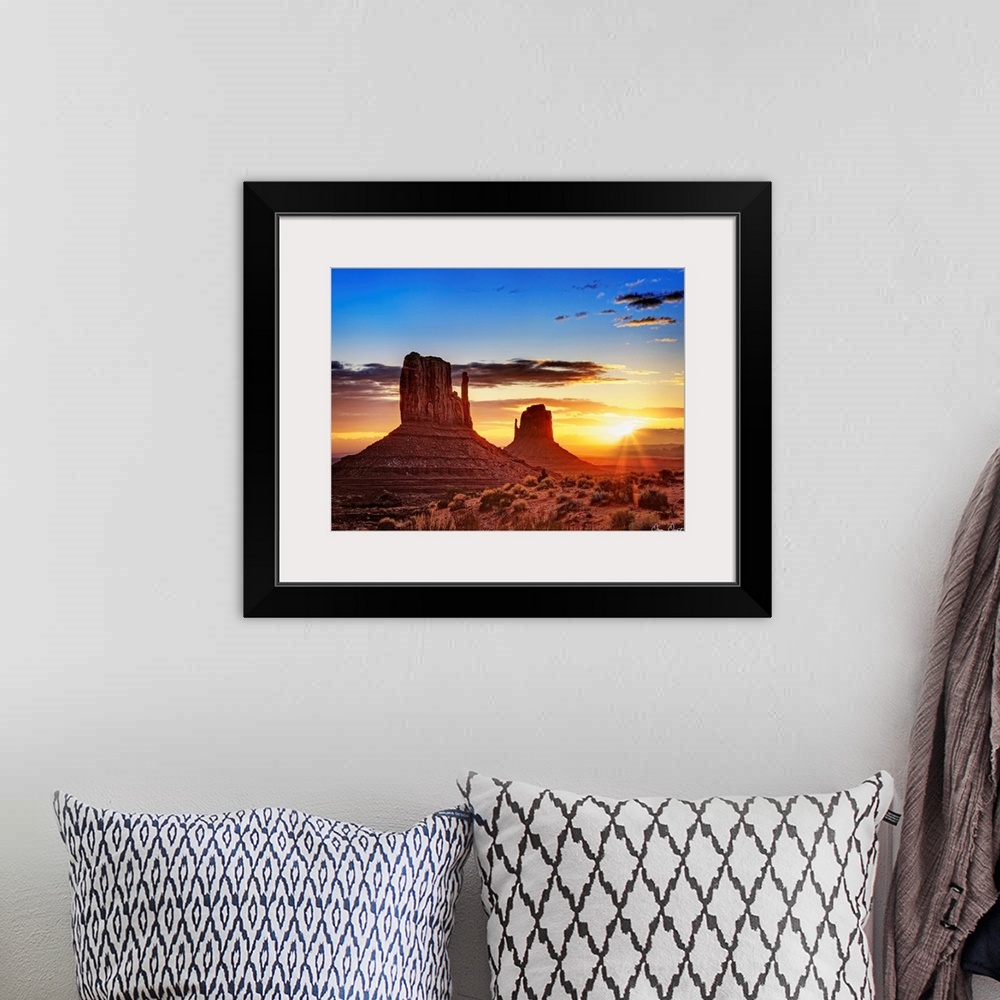A bohemian room featuring Landscape photograph of the buttes at Monument Valley in Arizona with a bright sunset in the back...