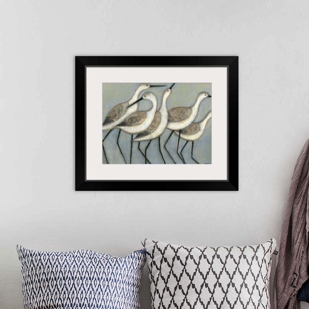 A bohemian room featuring A group of wader birds stand next to each other against a cool toned background.