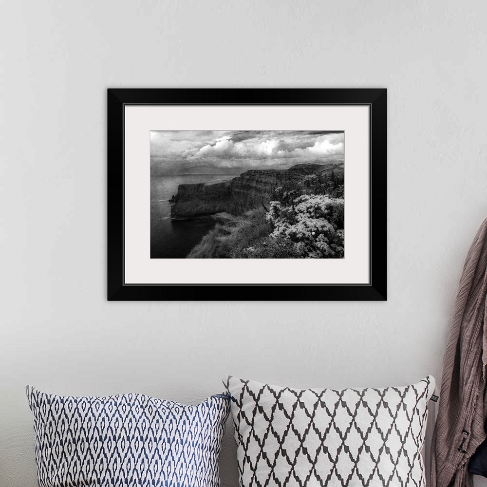 A bohemian room featuring Fine art photo of cliffs on the Irish coast under a stormy sky.